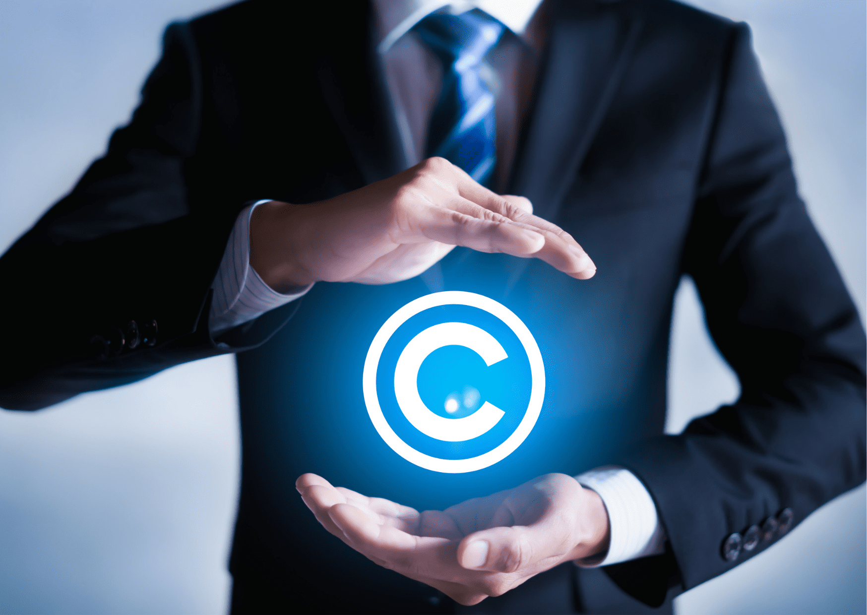 A human is protecting a copyright sign symbolizing intellectual property safeguarding in startups